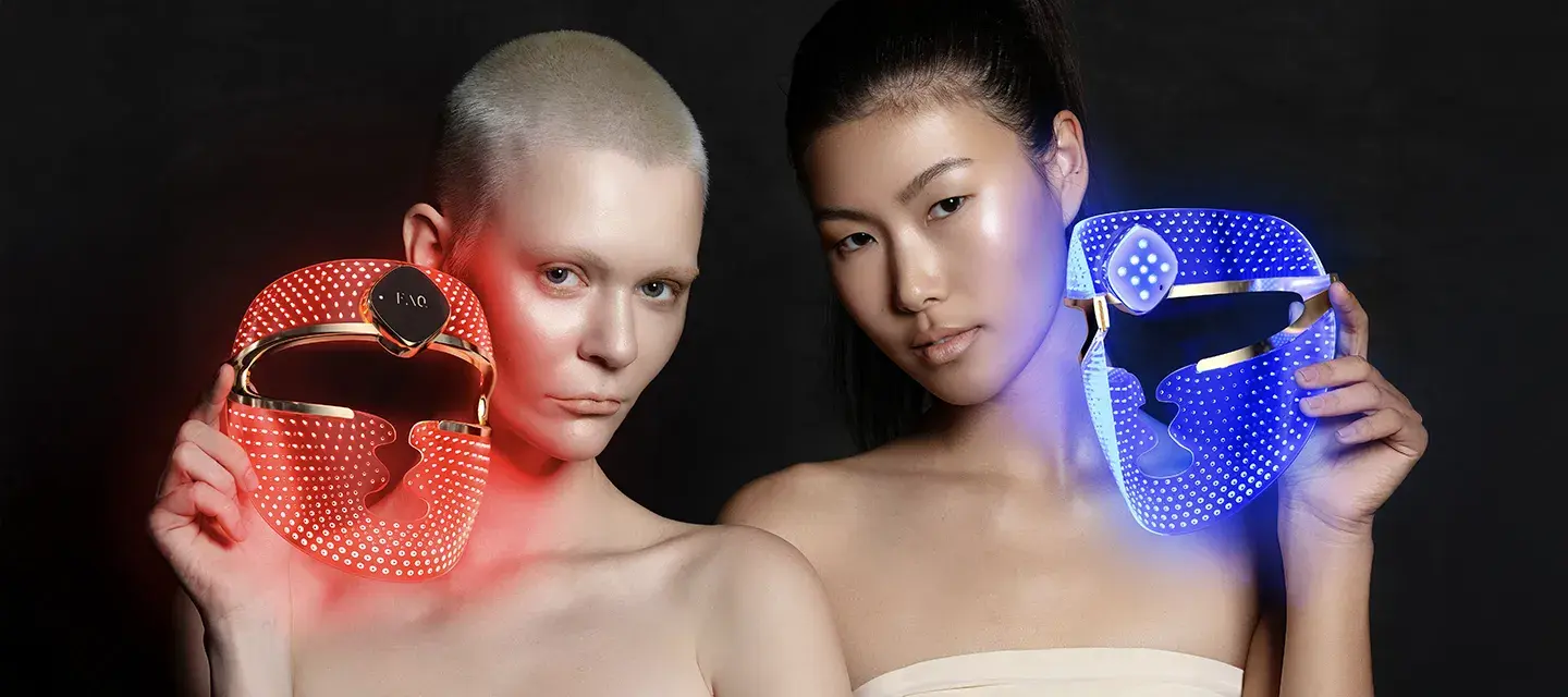 Two women with FAQ 202 plus LED light masks 